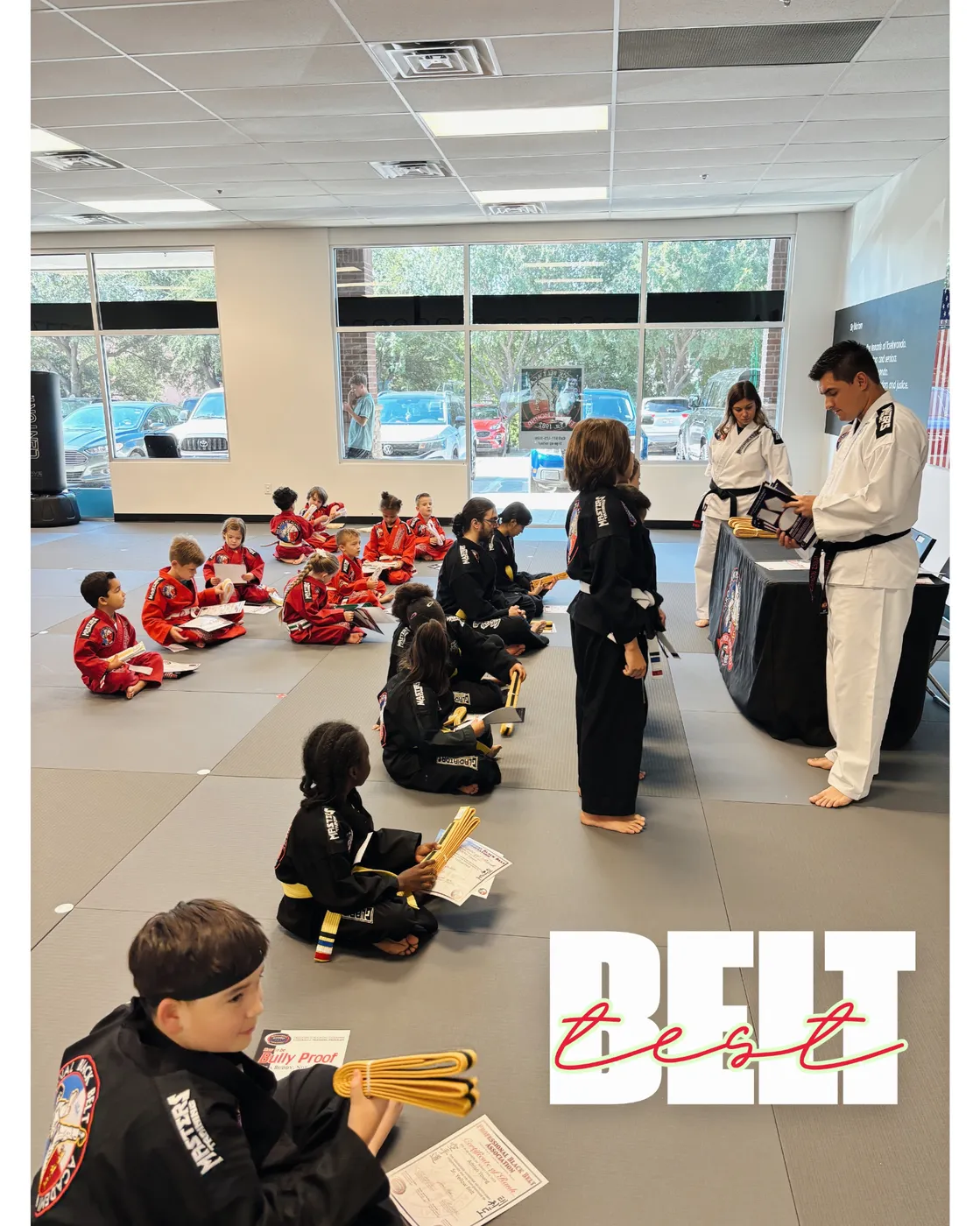 Students lined up in red doboks at a Pro Black Belt Academy belt test ceremony