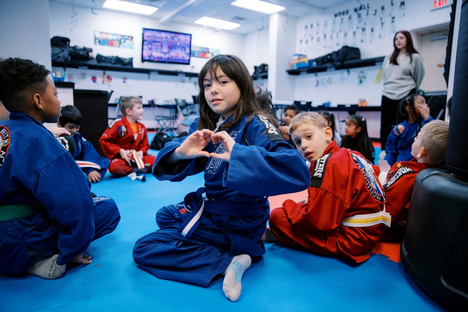 Students circled up during after-school class at Pro Black Belt Academy
